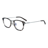 A pair of designer titanium eyeglasses with a dark gray and black marbled acetate front frame, silver metal bridge and temples, and clear lenses, shown on a plain white background.