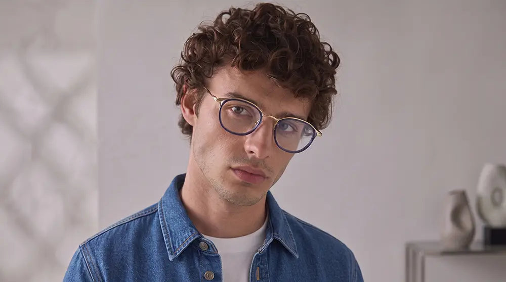 A men wearing a stylish designer prescription glasses in titanium