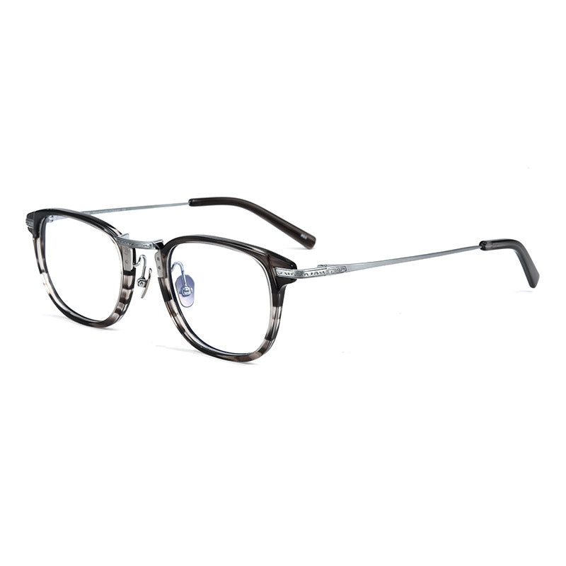 A pair of designer titanium eyeglasses with a dark gray and black marbled acetate front frame, silver metal bridge and temples, and clear lenses, shown on a plain white background.