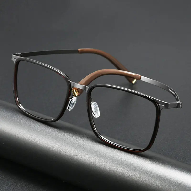 Rectangular Titanium Tortoise Glasses for Men and Women from Verhalo Vision, silver titanium temples, and brown temple tips, resting on a dark gray surface.