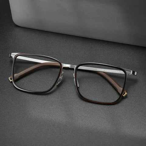 Rectangular Titanium Glasses for Men and Women from Verhalo Vision with a dark red TR90 front, silver-toned titanium temples, and gold-toned hinge accents, displayed on a dark gray surface with a gray case in the background.