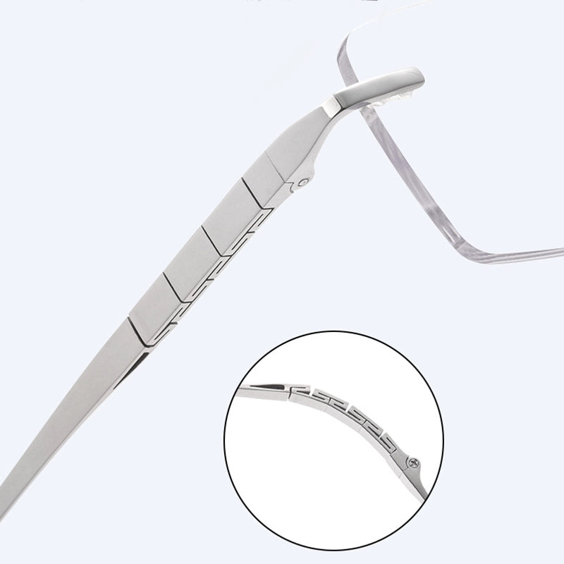 Silver titanium rimless spectacles arm detail with a circular inset showing the inner temple texture, on a light gray background.
