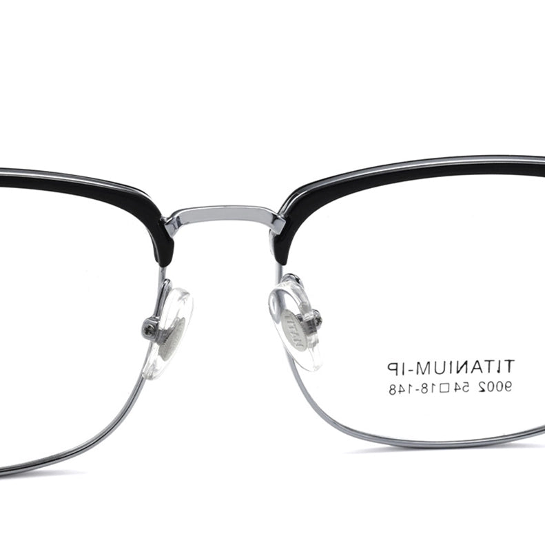 Close-up of a pair of titanium square browline magnetic frame glasses with a black acetate top frame, thin silver titanium lower rims, and clear nose pads on a white background. The inside of the right lens shows the text 'TITANIUM 54-18-148'.