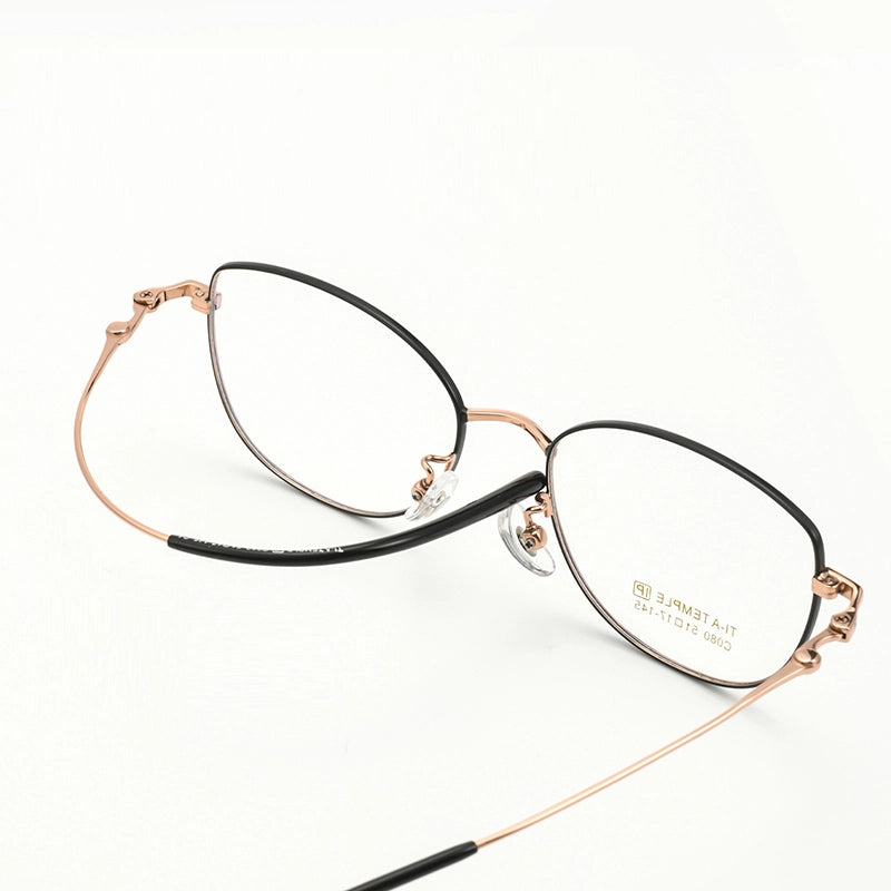 Cat Eye Full Rim Pure Titanium Eyeglasses with a black front and thin rose gold titanium arms, shown on a clean white background.