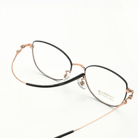 Cat Eye Full Rim Pure Titanium Eyeglasses with a black front and thin rose gold titanium arms, shown on a clean white background.
