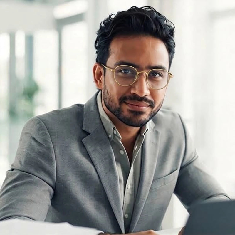 A men wearing a gold round pure titanium eyeglasses