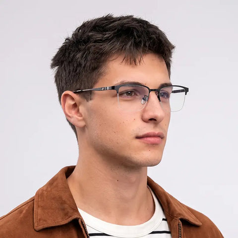 A man wearing black pure titanium magnetic glasses frames, shown in a close-up profile portrait against a light gray background.